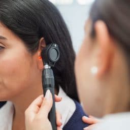Woman getting her ears checked by an audiologist