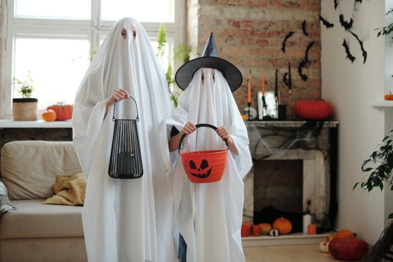 Parent and child dressed as ghosts for Halloween.
