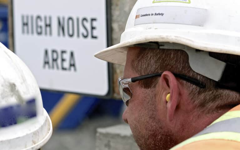 Construction worker wears ear plug